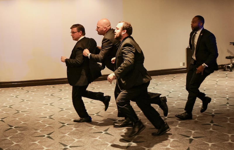 Security officials evacuate U.S. House Speaker Mike Johnson (R-LA) as a shooter opens fire during the annual White House Correspondents' Association dinner in Washington, D.C., U.S., April 25, 2026.