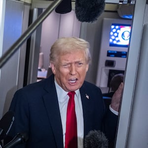 President Donald Trump speaks to the media aboard Air Force One on November 25, 2025 in flight en route to Florida.