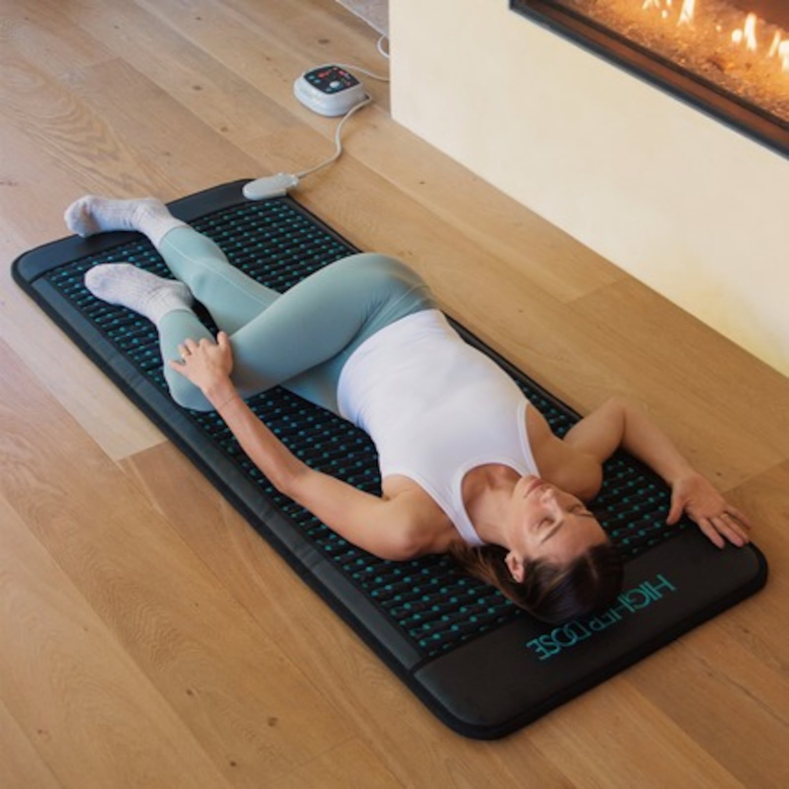 woman lying on PEMF infrared mat from HigherDOSE