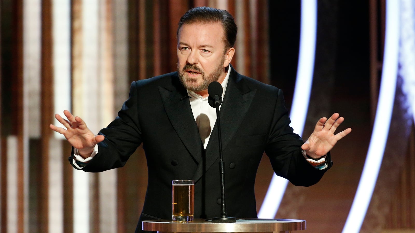 BEVERLY HILLS, CALIFORNIA - JANUARY 05: In this handout photo provided by NBCUniversal Media, LLC, host Ricky Gervais speaks onstage during the 77th Annual Golden Globe Awards at The Beverly Hilton Hotel on January 5, 2020 in Beverly Hills, California. (Photo by Paul Drinkwater/NBCUniversal Media, LLC via Getty Images)