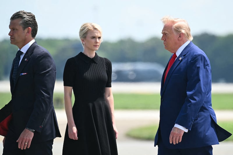 (L/R) US Secretary of Defense Pete Hegseth,  White House aide Natalie Harp, and US President Donald Trump attend a dignified transfer solemn event for US service members killed during operations in the Middle East, at Dover Air Force Base in Dover, Delaware, on July 22, 2026.  (Photo by SAUL LOEB / AFP via Getty Images)