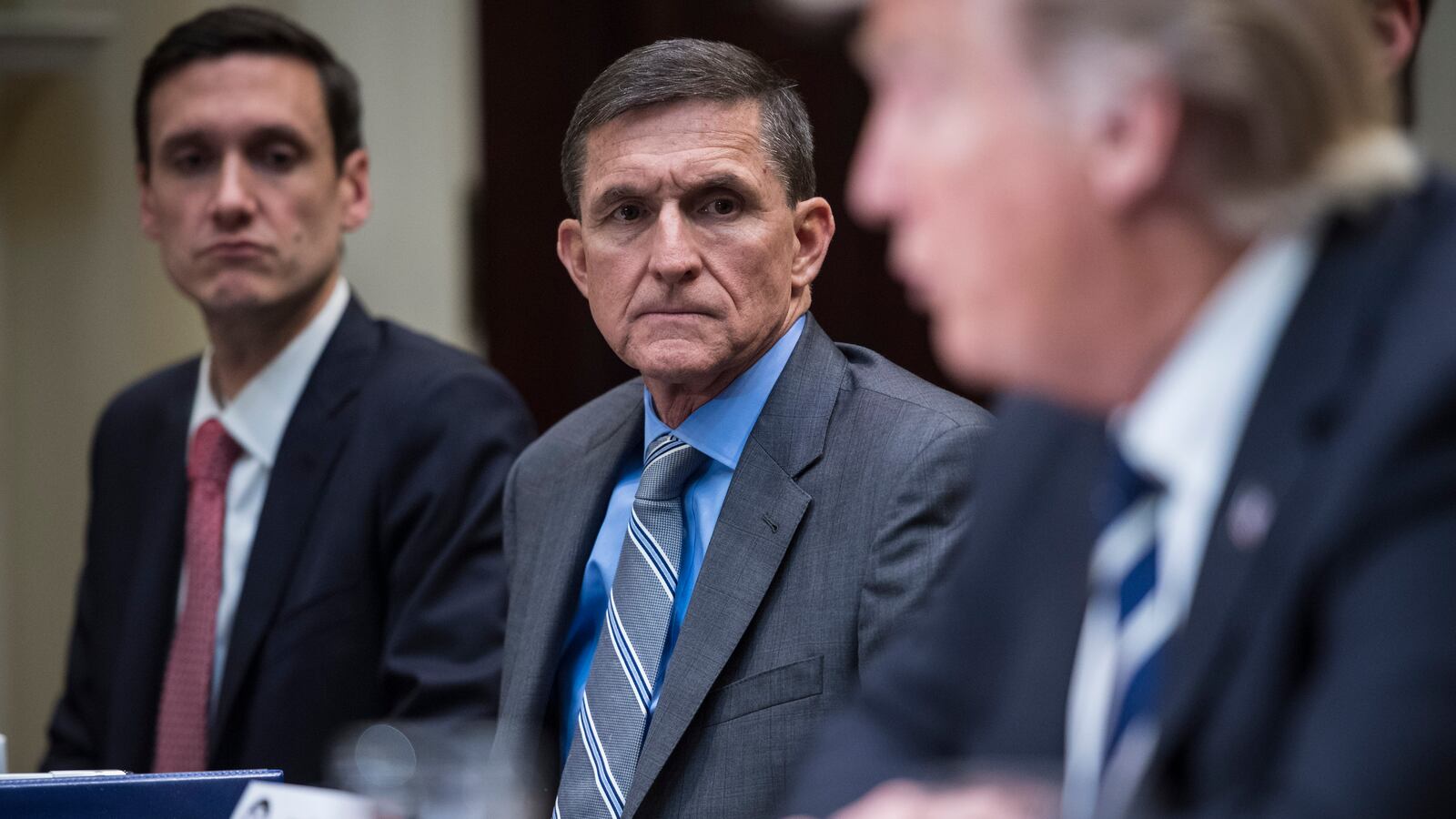 National Security Adviser Mike Flynn listens to President Trump during a listening session with cyber security experts in the Roosevelt Room the White House.