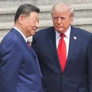 Chinese President Xi Jinping stands next to U.S. President Donald Trump during a welcome ceremony at the Great Hall of the People, in Beijing, China, May 14, 2026.