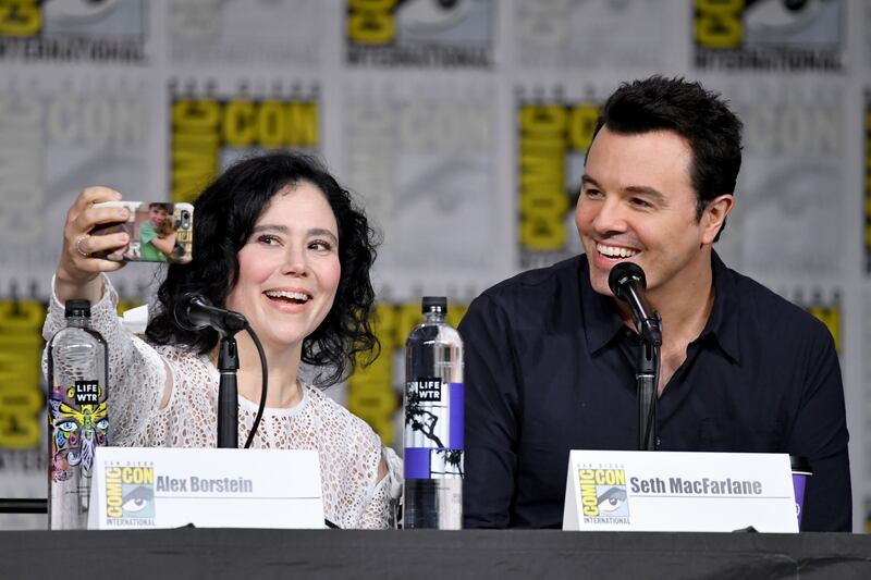 SAN DIEGO, CA - JULY 21: Alex Borstein (L) and Seth MacFarlane take a selfie onstage at the "American Dad" and "Family Guy" Panel during Comic-Con International 2018 at San Diego Convention Center on July 21, 2018 in San Diego, California. (Photo by Mike Coppola/Getty Images)