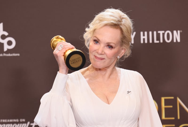 US actress Jean Smart wears a pin reading "Be Good", in tribute to Renee Good, who was fatally shot by a US Immigration and Customs Enforcement (ICE) agent in Minneapolis, as she poses in the press room with her award for Best Actress in a Television Series Musical or Comedy for "Hacks" during the 83rd annual Golden Globe Awards at the Beverly Hilton hotel in Beverly Hills, California, on January 11, 2026.