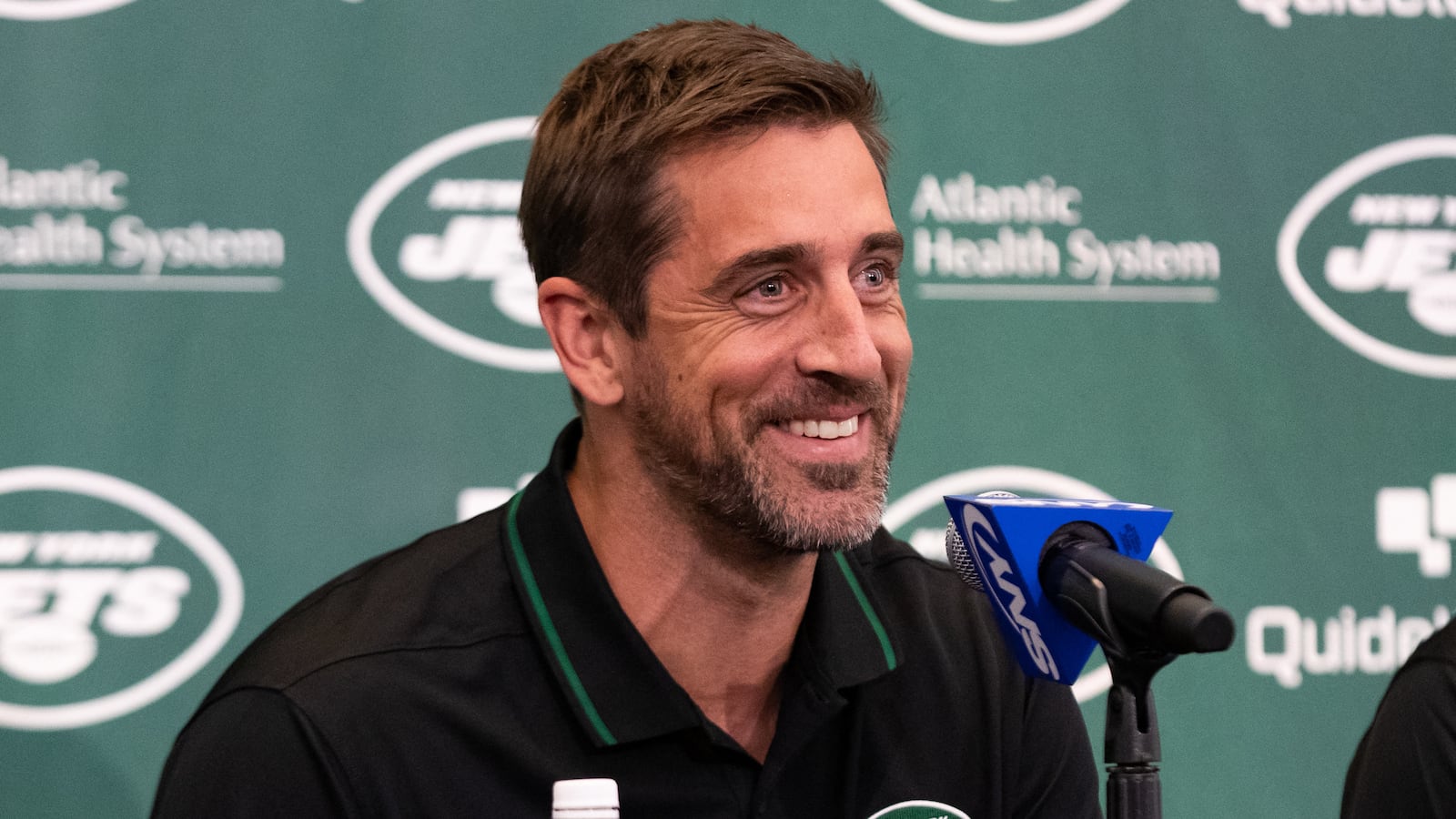 New York Jets quarterback Aaron Rodgers (8) talks to the media during the introductory press conference at Atlantic Health Jets Training Center.