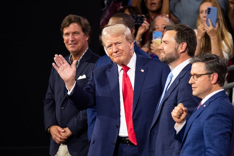 UNITED STATES - JULY 15: Former President Donald Trump waves to the crowd at the Republican National Convention at the Fiserv Forum in Milwaukee, Wisc., on Monday, July 15, 2024. Trump is flanked from left by Tucker Carlson, Rep. Byron Donalds, R-Fla., Vice-President nominee Sen. J.D. Vance, R-Ohio, and Speaker of the House Mike Johnson, R-La. (Bill Clark/CQ-Roll Call, Inc via Getty Images)