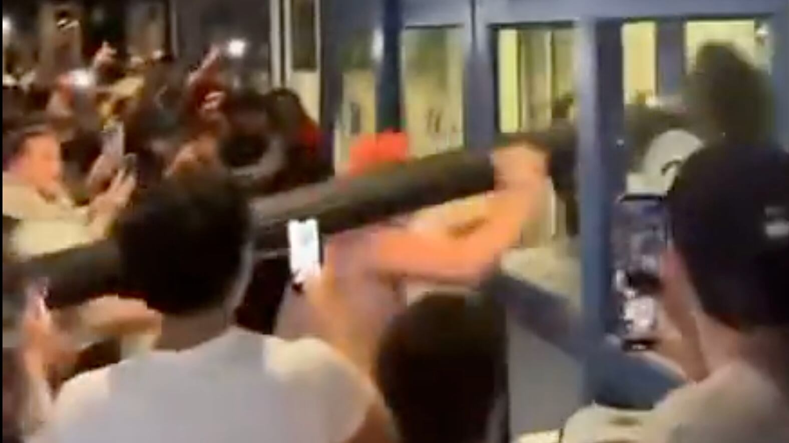 Uconn fans use a lamppost as a battering ram after NCAA title win.