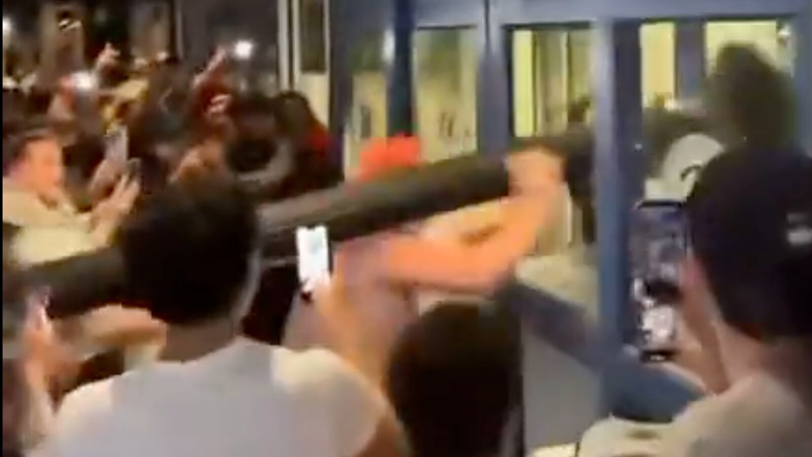 Uconn fans use a lamppost as a battering ram after NCAA title win.