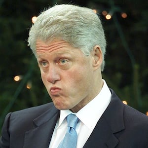 U.S. President Bill Clinton listens to speeches on stage at the Odyssey Centre in Belfast during Clinton's visit to Northern Ireland December 13, 2000.