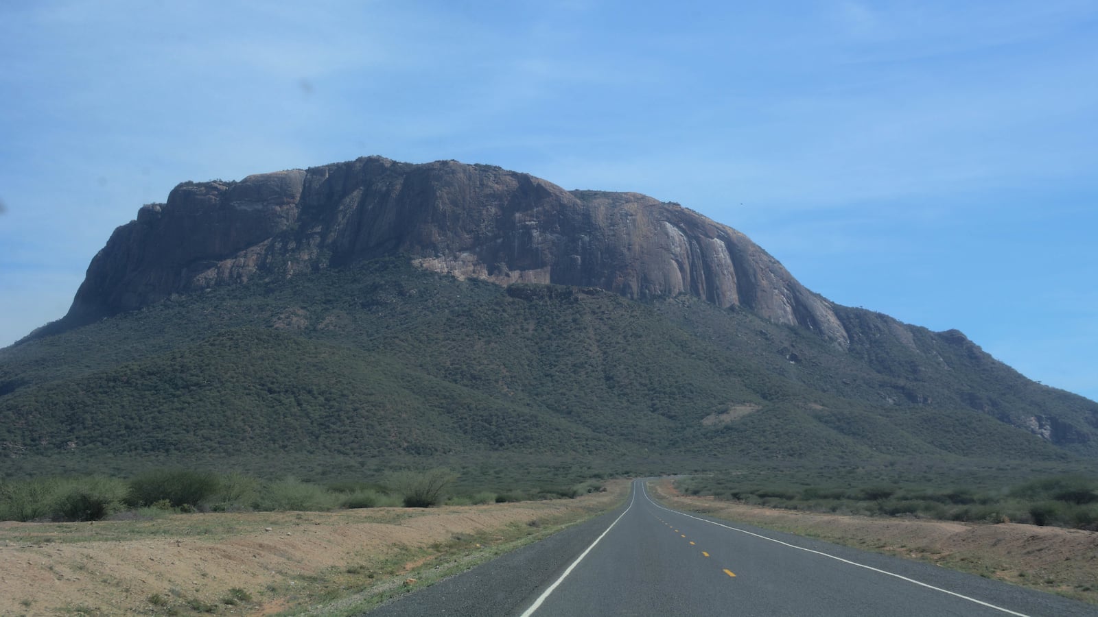 MARSABIT, KENYA - 2019/05/21: Mt. Ololokwe is seen in the background along the Great North Road also known as the Cape to Cairo Road.