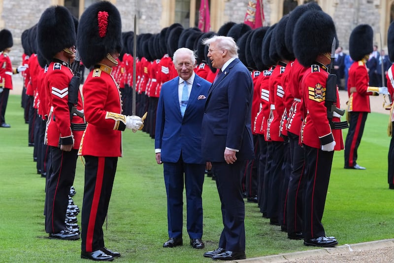 WINDSOR, ENGLAND - SEPTEMBER 17: King Charles III (C) and US President Donald Trump review the Guard of Honour at Windsor Castle on day two of the US President Donald Trump's second state visit to the UK on September 17, 2025 in Windsor, England. (Photo by Kirsty Wigglesworth - WPA Pool/Getty Images)