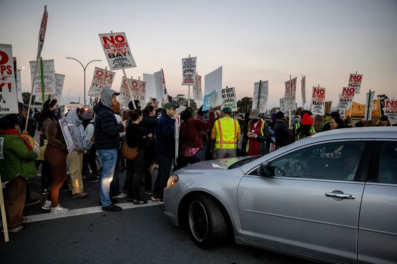 Protesters block a road to Coast Guard Island Alameda during a protest where federal law enforcement agents