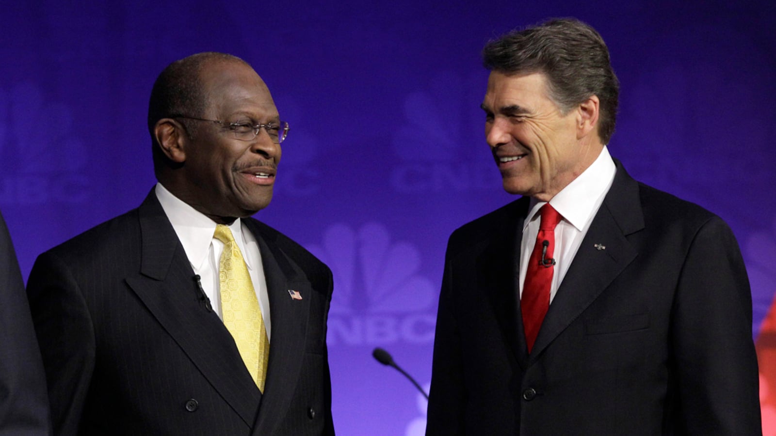 articles/2011/11/11/rick-perry-s-dogged-damage-control/herman-cain-rick-perry-lawrence_y2hxwf