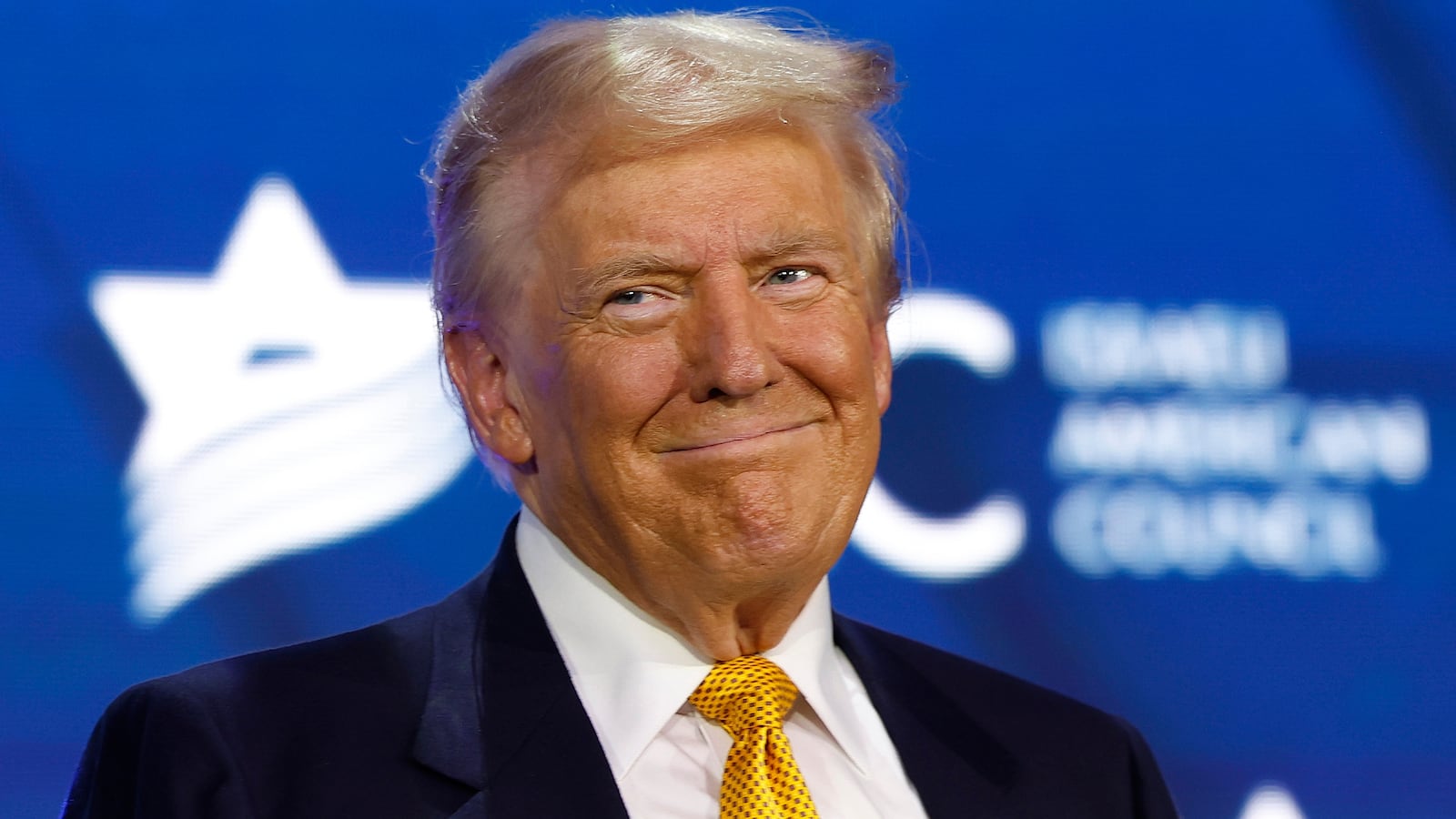 Donald Trump smiles as he appears at the Israeli American Council National Summit at the Washington Hilton