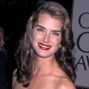 Actress Brooke Shields appears in a red dress on the 55th Annual Golden Globe Awards red carpet in 1998.