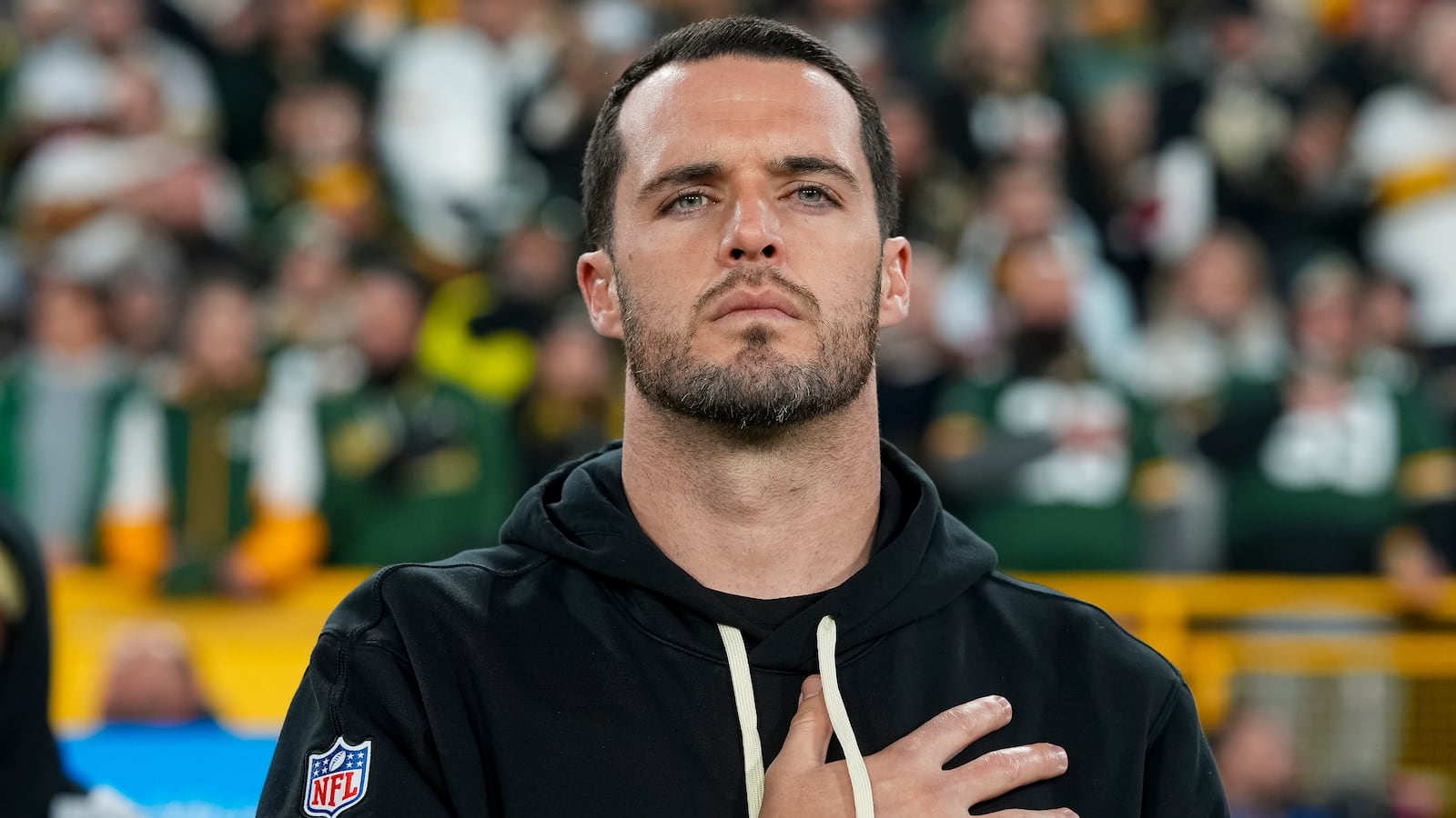 GREEN BAY, WISCONSIN - DECEMBER 23: Quarterback Derek Carr #4 of the New Orleans Saints stands on the sidelines during the national anthem prior to an NFL football game against the Green Bay Packers, at Lambeau Field on December 23, 2024 in Green Bay, Wisconsin. (Photo by Todd Rosenberg/Getty Images)