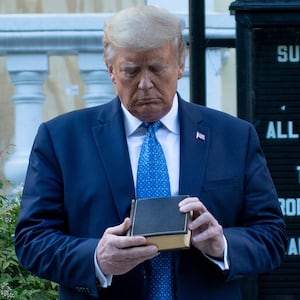 US President Donald Trump holds a Bible while visiting St. John's Church across from the White House after the area was cleared of people protesting the death of George Floyd June 1, 2020, in Washington, DC. - US President Donald Trump was due to make a televised address to the nation on Monday after days of anti-racism protests against police brutality that have erupted into violence.
The White House announced that the president would make remarks imminently after he has been criticized for not publicly addressing in the crisis in recent days. (Photo by Brendan Smialowski / AFP) (Photo by BRENDAN SMIALOWSKI/AFP via Getty Images)