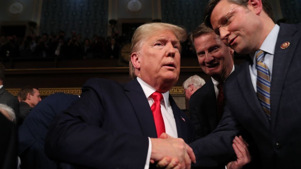 U.S. President Donald Trump is greeted by Rep. Mike Johnson.