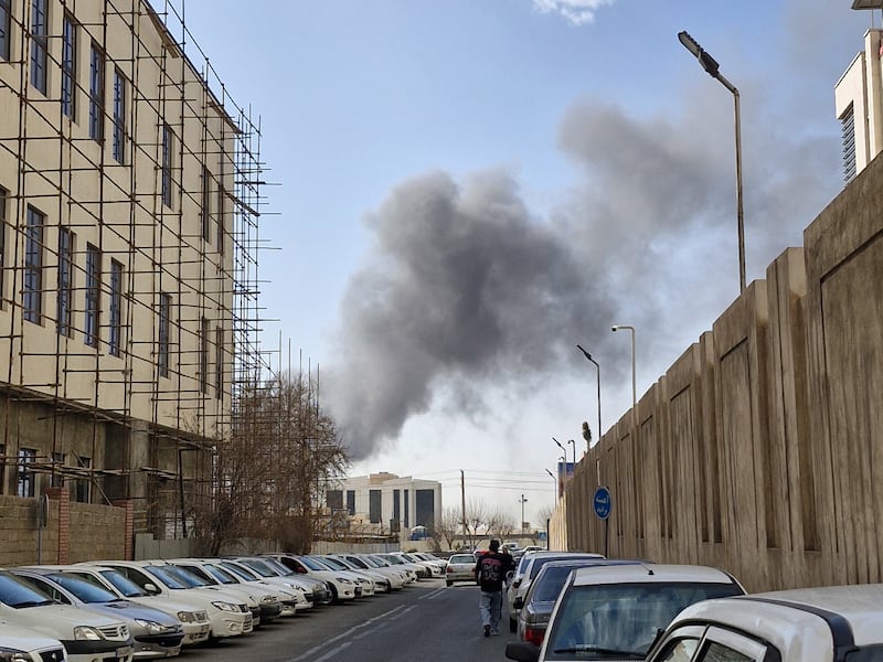 A plume of smoke rises over Tehran after a reported explosion on February 28, 2026, after Israel said it carried out a "preemptive strike" on Iran as sirens sounded in Jerusalem and phone alerts warned of an "extremely serious" threat. (Photo by Ehsan / Middle East Images / AFP via Getty Images)