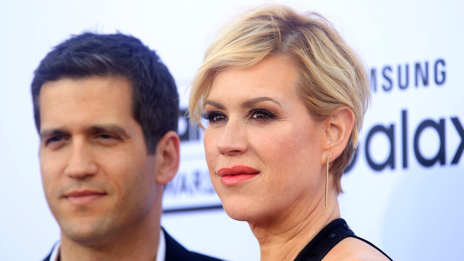 Molly Ringwald (right) and her husband Panio Gianopoulos (left) pose for photographers.