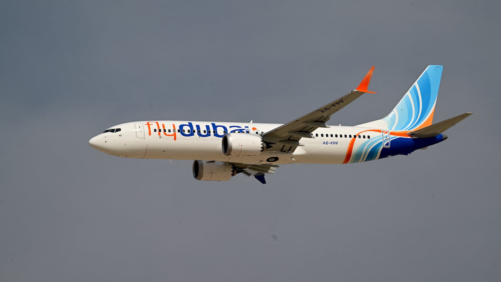 A Flydubai Boeing 737 MAX 8 performs a display flight at Al-Maktoum International Airport during the Dubai Airshow 2025 in Dubai on November 17, 2025.