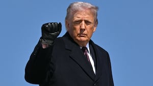 U.S. President Donald Trump pumps his fist as he boards Air Force One at Joint Base Andrews in Maryland before departing for Texas on February 27, 2026.
