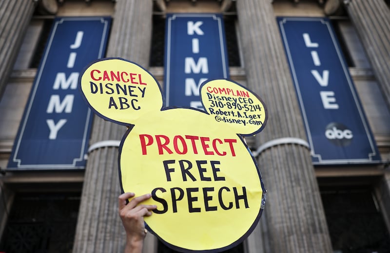 A demonstrator waves a "Protect Free Speech" sign following a protest against the suspension of the "Jimmy Kimmel Live!" show, held near the theater where the show is produced in Hollywood, on September 22, 2025 in Los Angeles, California. A contingent of Hollywood union members, along with Democratic members of the House of Representatives, participated in the event "to defend Americans' constitutional right to free speech.” Kimmel's ABC late-night show has been "indefinitely" taken off the air following controversy over his comments about the killing of Charlie Kirk.