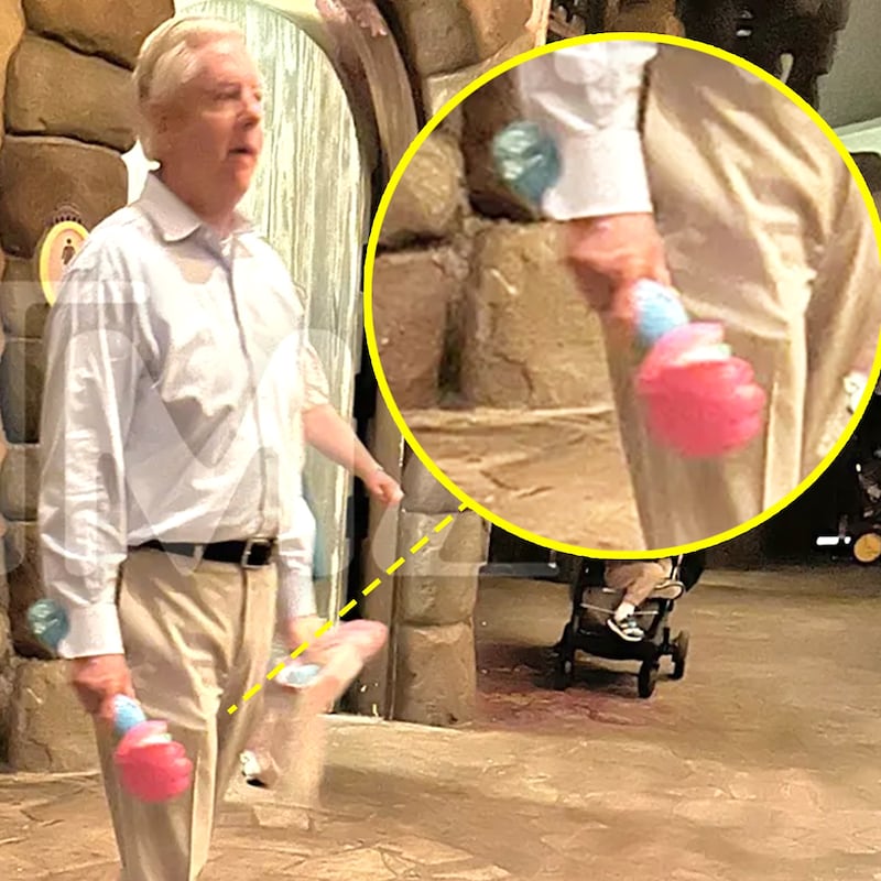 Sen. Lindsey Graham walking with a bubble wand at Disney World.