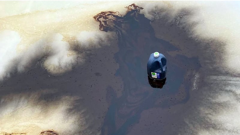 A gallon-sized container is visible amid a dark liquid smeared across the outdoor ice rink at the Trump-Kennedy Center.