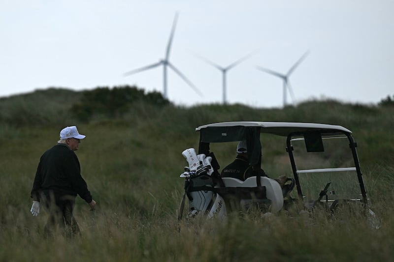 President Donald Trump (L), backdropped by Turbines at the European Offshore Wind Deployment Centre, also known as the Aberdeen Bay Wind Farm, in Balmedie, Aberdeenshire, north east Scotland on July 29, 2025.