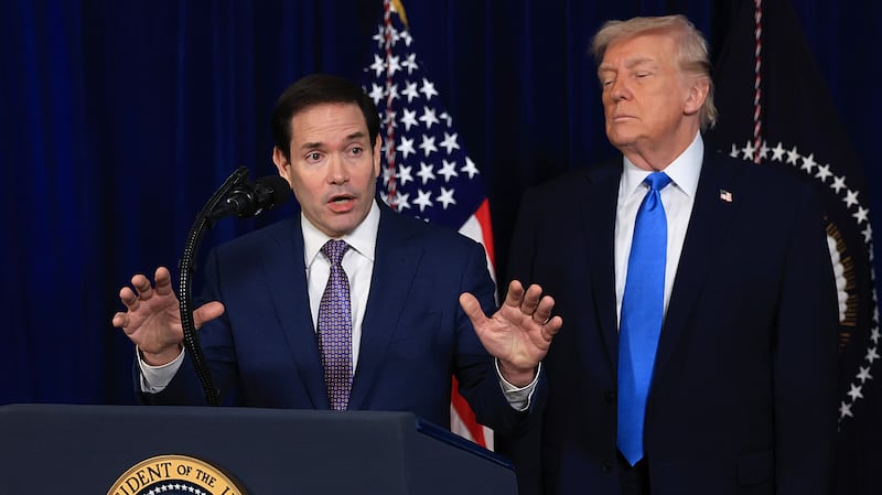 PALM BEACH, FLORIDA - JANUARY 03: Secretary of State Marco Rubio speaks during a press conference as Homeland Security Advisor Stephen Miller and U.S. President Donald Trump listen at Mar-a-Lago club on January 03, 2026, in Palm Beach, Florida. During the event, President Trump confirmed that the United States military carried out a large-scale strike in Caracas overnight, resulting in the capture of Venezuelan leader Nicolás Maduro and his wife, Cilia Flores. (Photo by Joe Raedle/Getty Images)