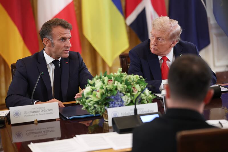 U.S. President Donald Trump (right) sits next to French President Emmanuel Macron (left) at the White House on August 18, 2025, during meetings to discuss a peace deal between Russia and Ukraine.