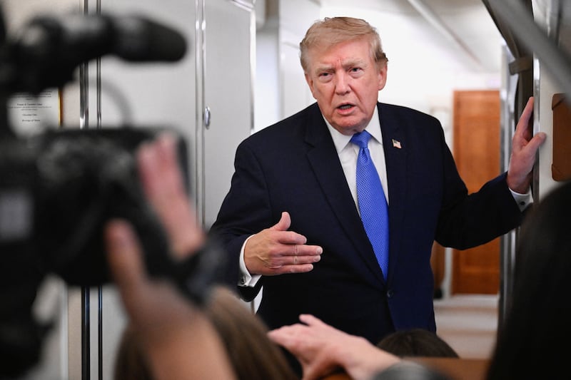 U.S. President Donald Trump speaks to the media aboard Air Force One en route to Joint Base Andrews, in Maryland, U.S., August 2, 2026.