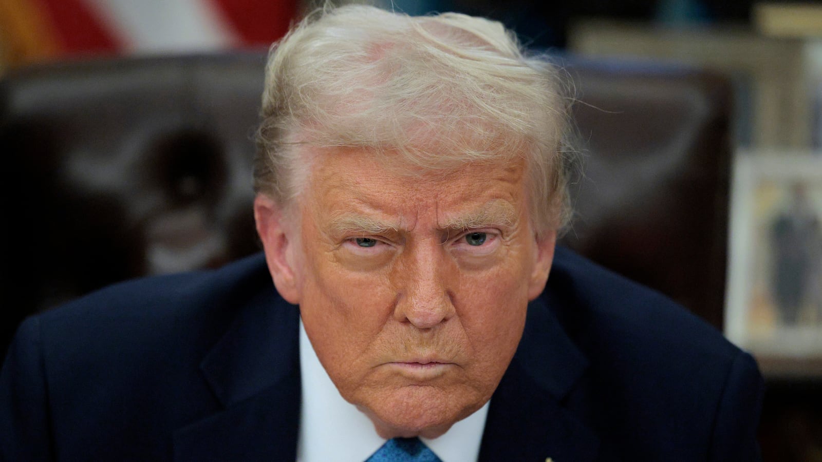 Donald Trump talks to reporters after signing an executive order.