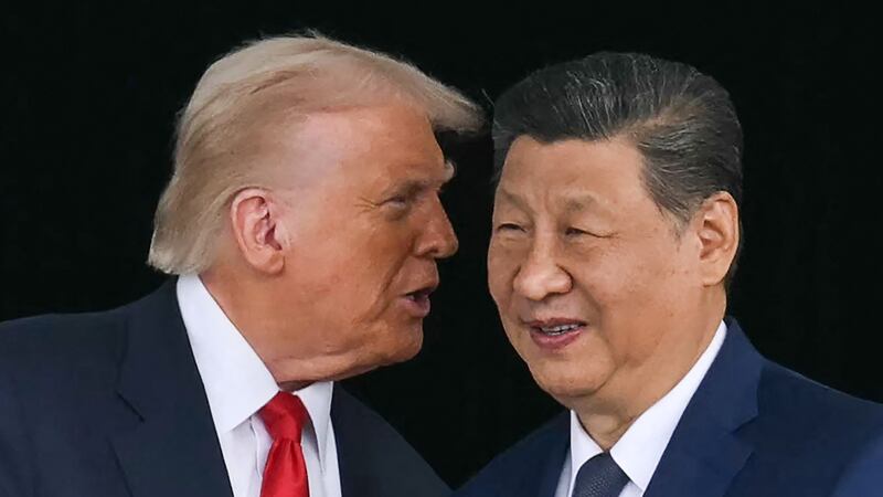 US President Donald Trump (L) talks to China's President Xi Jinping.