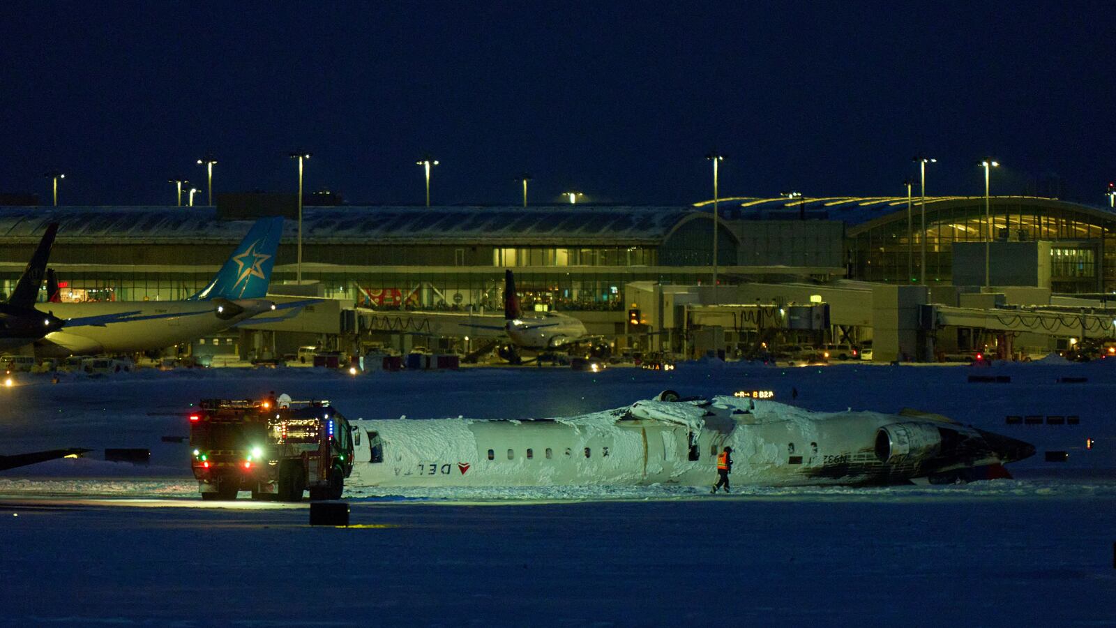 A Delta airlines plane sits on its roof after crashing upon landing at Toronto Pearson Airport in Toronto, Ontario, on February 17, 2025.