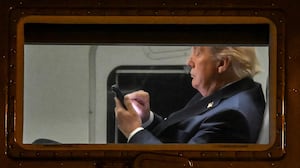 US President Donald Trump uses a cellphone