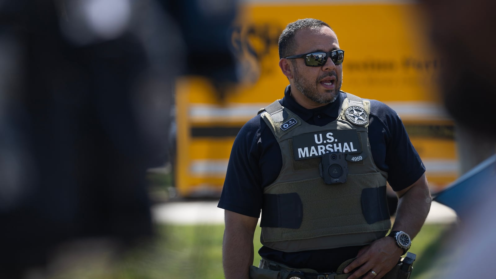 BENSENVILLE, ILLINOIS - SEPTEMBER 10: A U.S. Marshal stands guard outside Midwest Distribution during a press conference after it was raided by federal agents on September 10, 2025 in Bensenville, Illinois. According to the company, various e-liquids were seized in the raid. (Photo by Scott Olson/Getty Images)