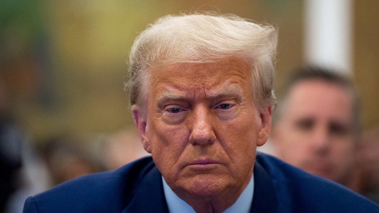 A photo of Donald Trump sitting in court.