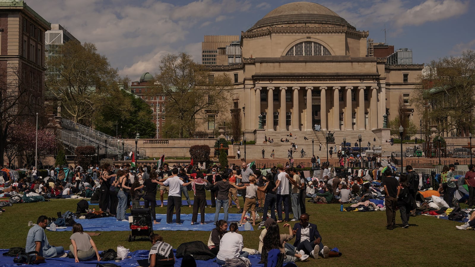Protesters lead a demonstration on the campus of Columbia University during the daytime.