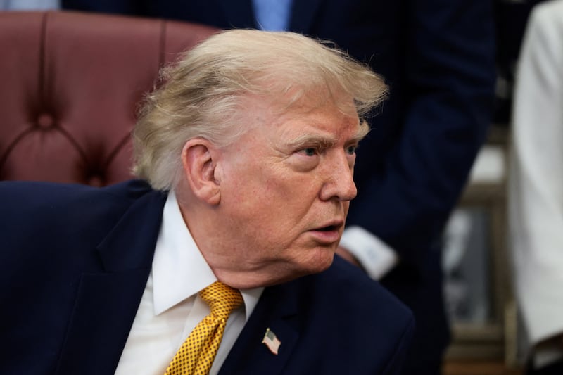 U.S. President Donald Trump answers questions from the media after signing an executive order establishing the President's Military Spouse Commission to be chaired by Jennifer Rauchet, wife of Secretary of Defense Pete Hegseth, in the Oval Office at the White House in Washington, D.C., U.S., August 3, 2026.