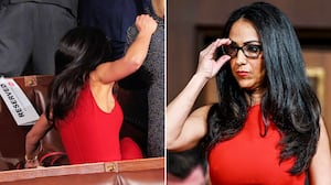 Lauren Boebert (R-CO) grabs onto a fellow member of Congress as she falls off of the seat she was standing in to watch President Donald Trump depart after a joint session of Congress at the Capitol on Feb. 24, 2026.