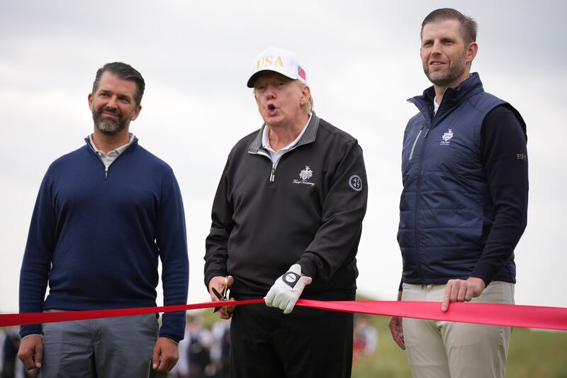 speaks next to Donald Trump Jr. (L) and Eric Trump as they attend the ribbon-cutting ceremony at a new 18-hole course at Trump International Golf Links on July 29, 2025 in Balmedie, near Aberdeen, Scotland. President Trump is visiting Scotland in a trip that’s part-vacation, part-work, as he stayed at his Trump Turnberry golf course, followed by Trump International Golf Links in Aberdeenshire, between July 25 to 29.  (Photo by Andrew Harnik/Getty Images)
