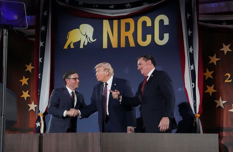 U.S. President Donald Trump shakes hands with House Speaker Mike Johnson (R-LA) next to U.S. Rep. Richard Hudson (R-NC), NRCC Chairman, during the National Republican Congressional Committee (NRCC) annual fundraising dinner in Washington, D.C., U.S., March 25, 2026.