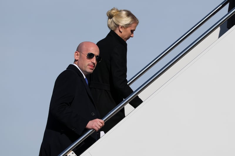 JOINT BASE ANDREWS, MARYLAND - JANUARY 27: Politcal advisor Stephen Miller (L) and White House assistant to the President Natalie Harp walk up the airstairs as he boards Air Force One on January 27, 2026 at Joint Base Andrews, Maryland.  President Trump is en route to Clive, Iowa for a rally with supporters where he is expected to talk about energy and the economy in his speech.  (Photo by Win McNamee/Getty Images)