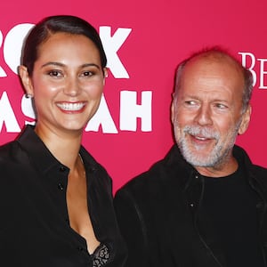 Cast member Bruce Willis arrives with Emma Heming Willis for the premiere of the film "Rock the Kasbah" in New York October 19, 2015.