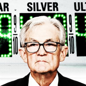 Jerome Powell in front of a gas sign.