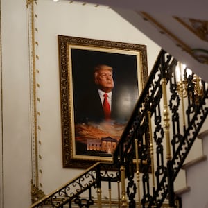 A portrait of former President Donald Trump over the White House is seen on a stairway of his Mar-a-Lago estate.