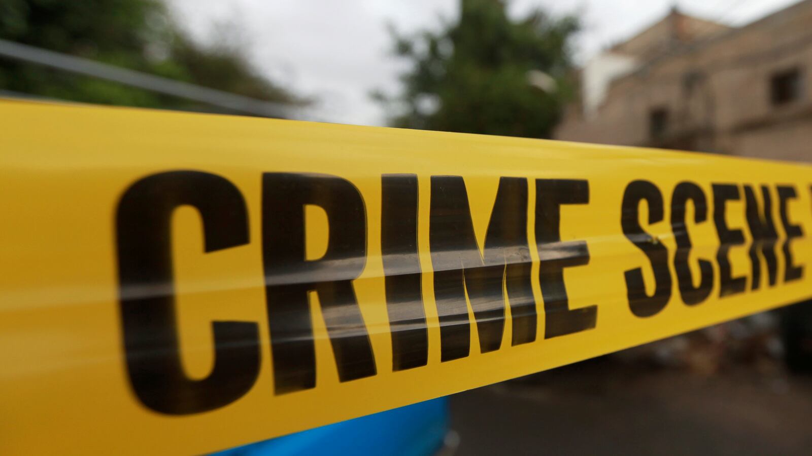 Yellow police tape hangs at a crime scene.